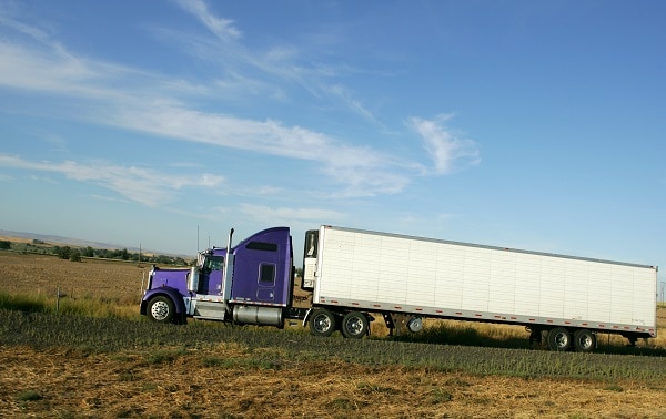 A Semi truck going fast on interstate highway