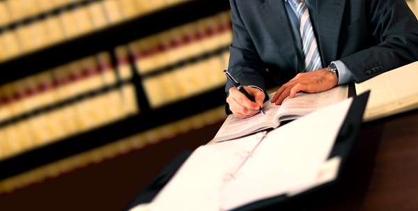 An Attorney takes notes during a consultation with a new client