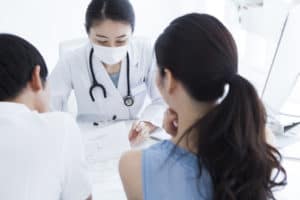 An doctor discusses health with a couple