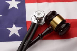 Wooden Gavel And Stethoscope an American Flag