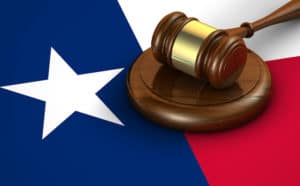 A Legal Gavel rests atop the Texas Flag
