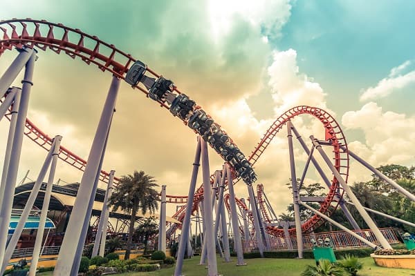 A Rollercoaster speeds around a loop at an Amusement Park