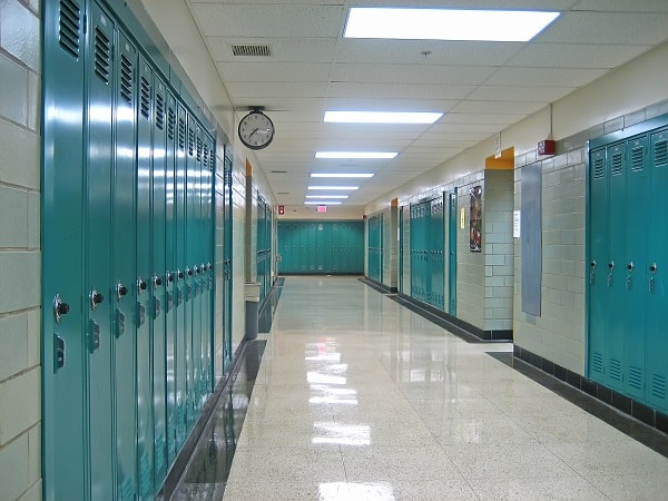 Lockers line an Empty Hallway in a Public School