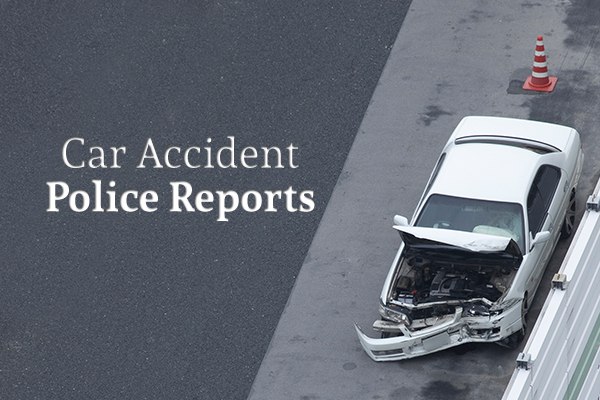 A white car that has been in a car accident sits on the highway shoulder beside the words "Car Accident Police Reports"