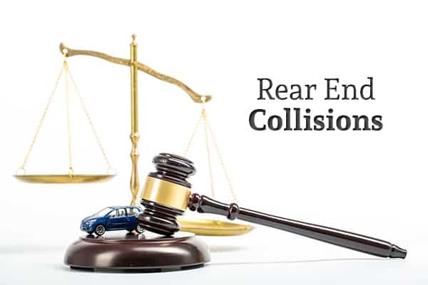 A toy car sits on a gavel base beside a gavel with scales in the background and the words "Rear End Collisions"