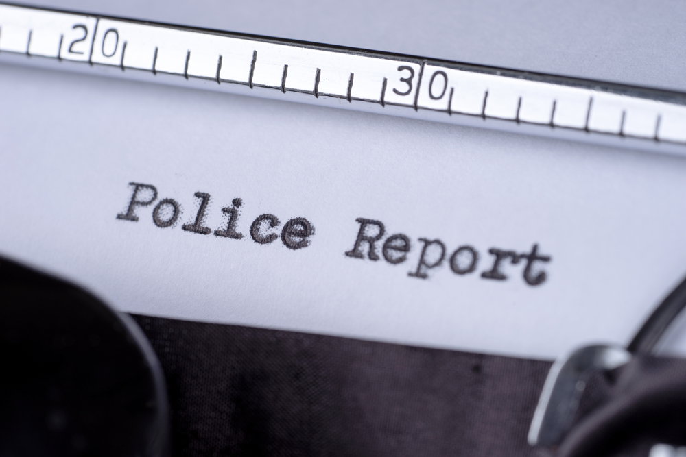 Close-up of a typewritten police report document related to a car accident case.