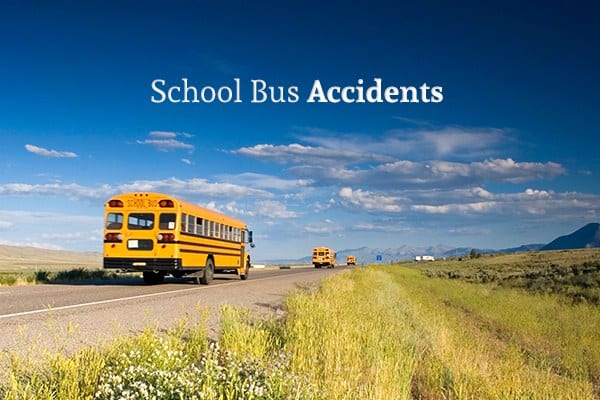 A country road with two school buses driving off into the distance beneath the words "School Bus Accidents"