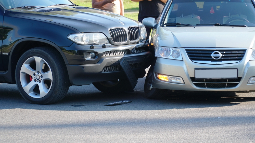 Two vehicles with significant front-end damage after a collision, illustrating one of the common causes of car accidents