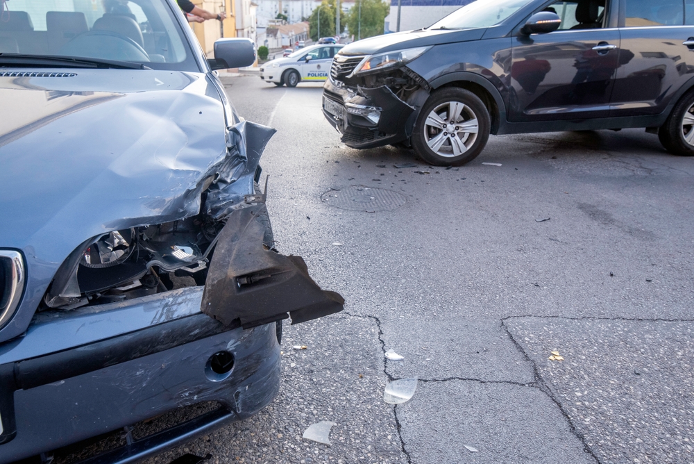 Multiple vehicles with front-end damage at an intersection crash scene, representing frequent causes of car accidents