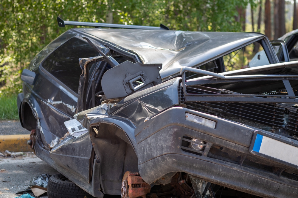 Severely damaged car after a wreck, showing extensive body damage commonly seen in high-impact Texas crashes