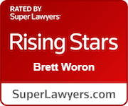 Red badge indicating that Brett Woron is rated one of the Rising Stars by SuperLawyers.com