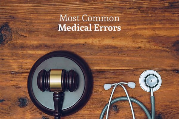 A gavel beside a stethoscope on a desk under the words most common medical errors
