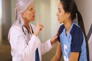 A doctor checking a young soccer player for a concussion.