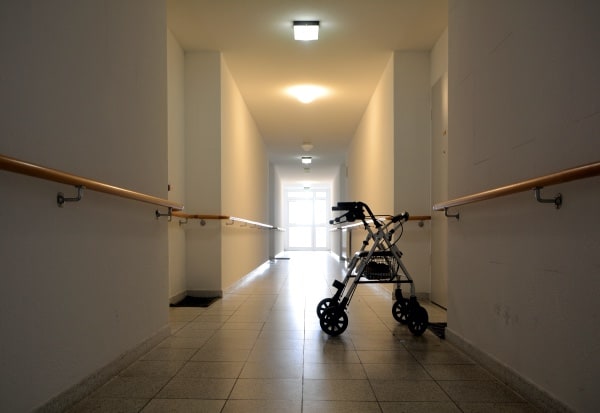 A walker alone in the middle of a hallway.