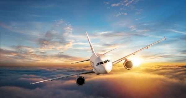 A commercial airline flying high in the clouds.