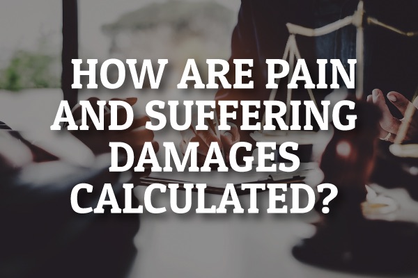 A lawyer sitting at a desk with the words, "how are pain and suffering damages calculated?"