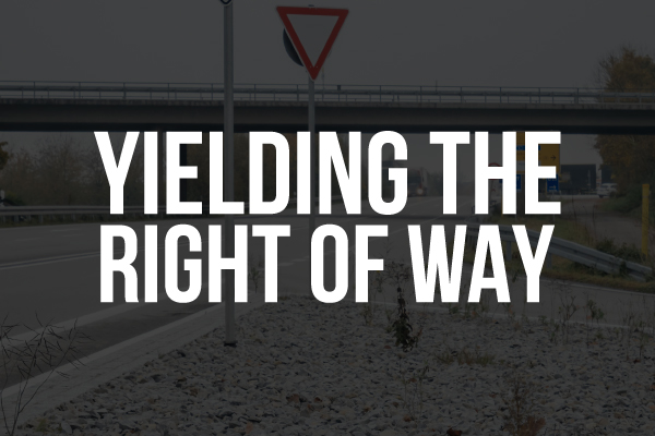 A yield sign on an off-ramp with the words, "yielding the right of way."