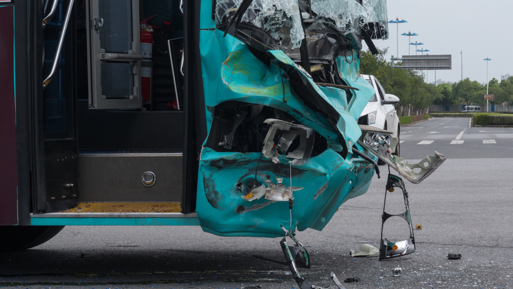Front of a bus severely damaged after a rear-end collision on a city street in Arlington, Texas