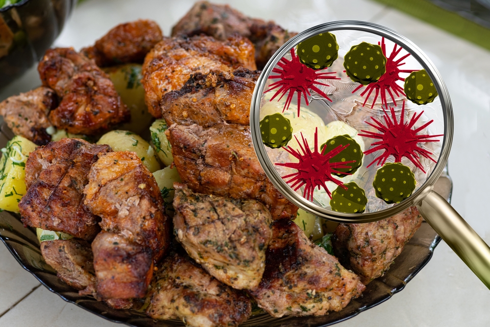 Magnified view of bacteria on cooked meat, symbolizing food contamination and food poisoning risk