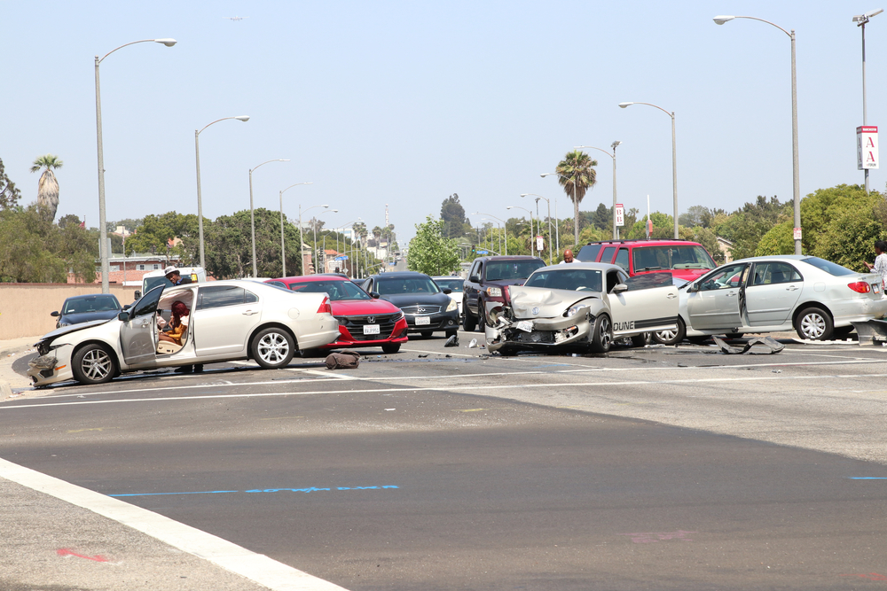Multiple damaged cars blocking an intersection after a multi-vehicle collision in Texas.