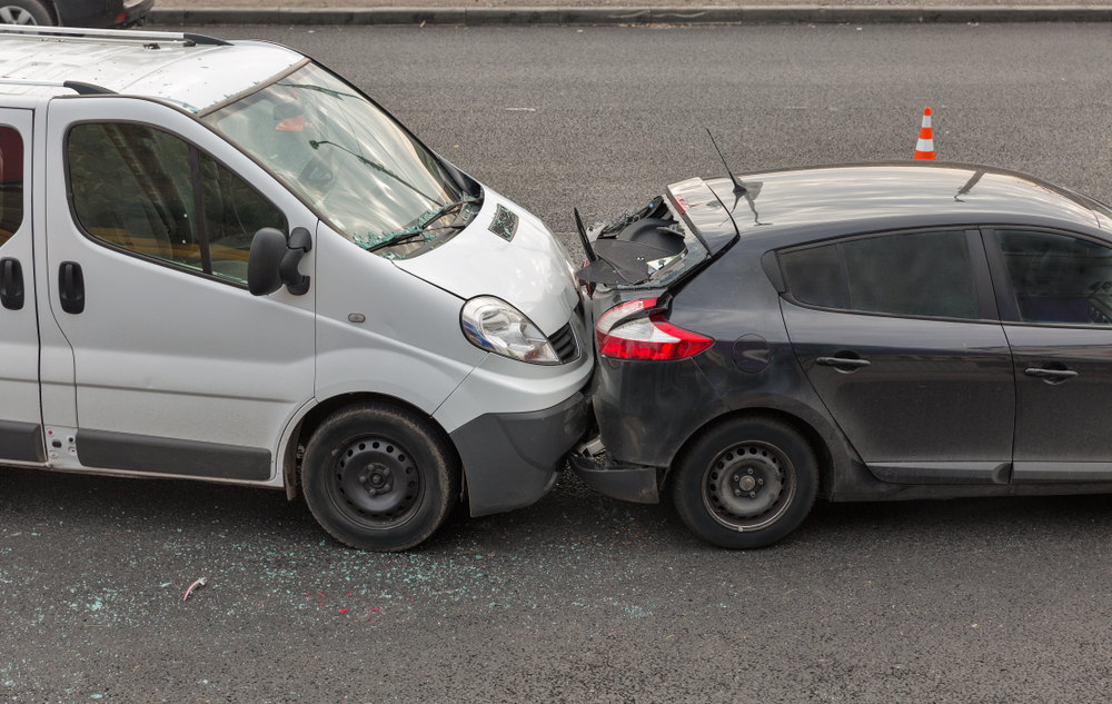White van and black car involved in a rear-end collision on an Arlington road.