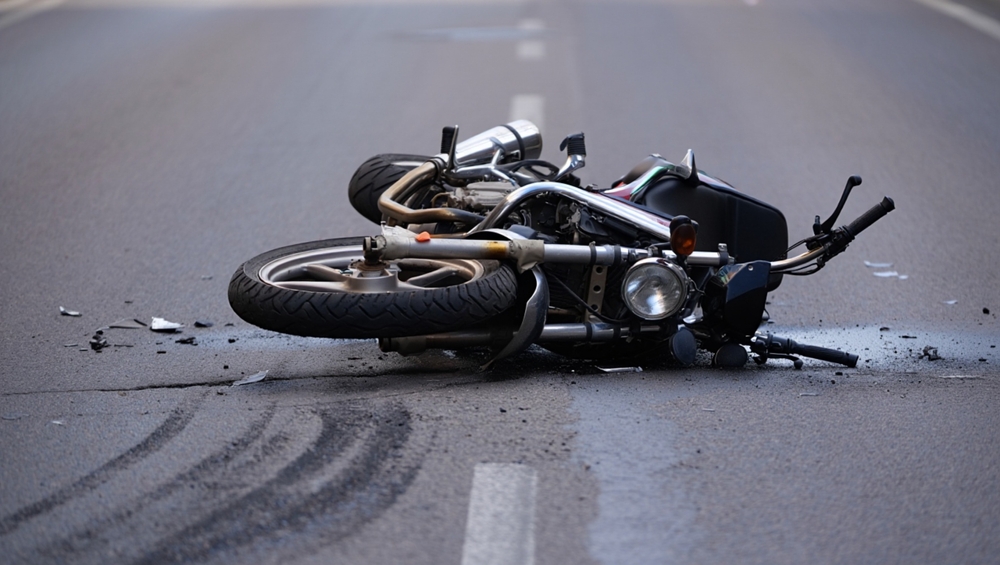 Motorcycle lying on the road with skid marks, demonstrating how investigators analyze fault in Texas motorcycle wrecks.