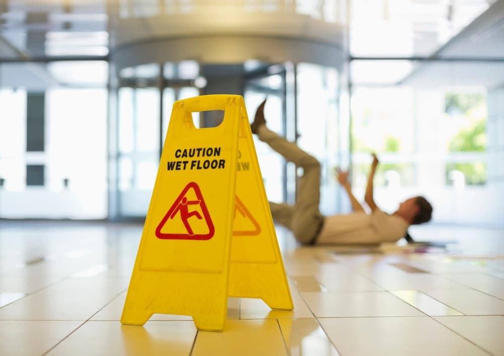 A man slipped on a office wet floor.