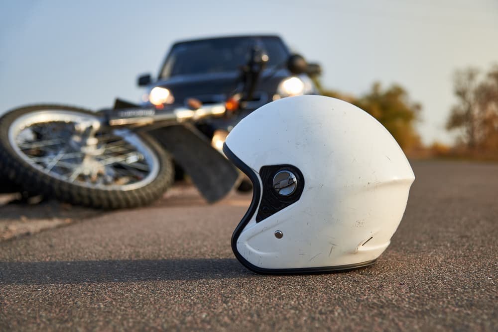 Photo of car, helmet and motorcycle on road - Concept of Motorcycle Accident