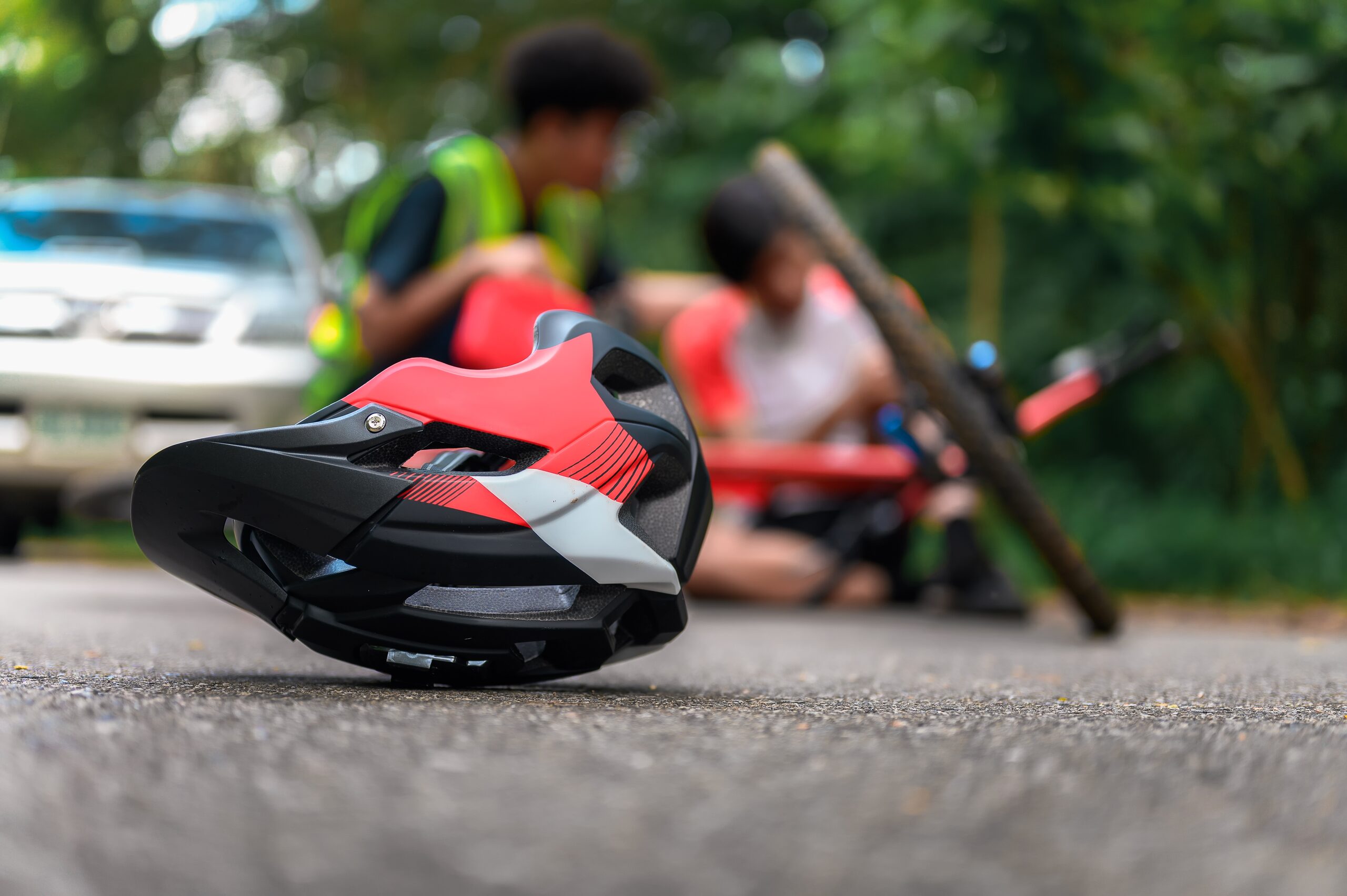 Bicycle helmet on pavement after a crash in Arlington, related to how long a bicycle accident claim usually takes in Texas.