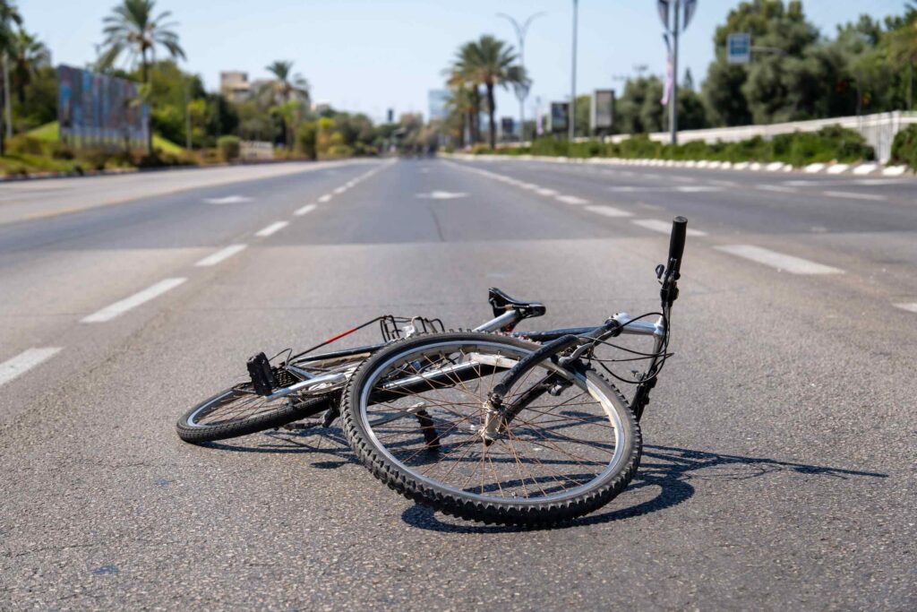 Damaged bicycle left in the street after an accident in Arlington, representing how long a bicycle accident claim usually takes in Texas.Damaged bicycle left in the street after an accident in Arlington, representing how long a bicycle accident claim usually takes in Texas.