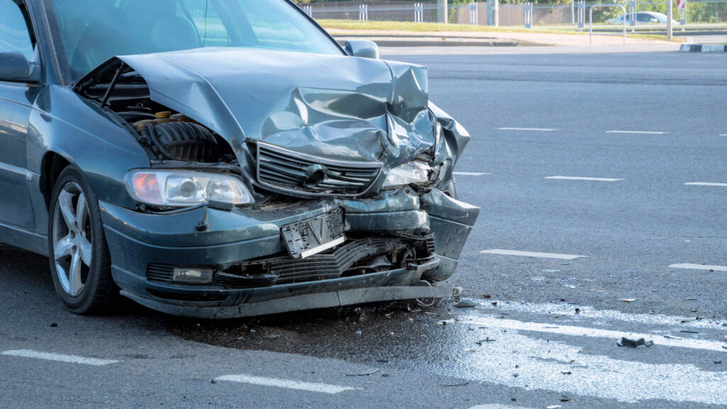 Severe front-end collision damage on a vehicle in Arlington, illustrating the complex process of how to tell who is at fault in a car accident.
