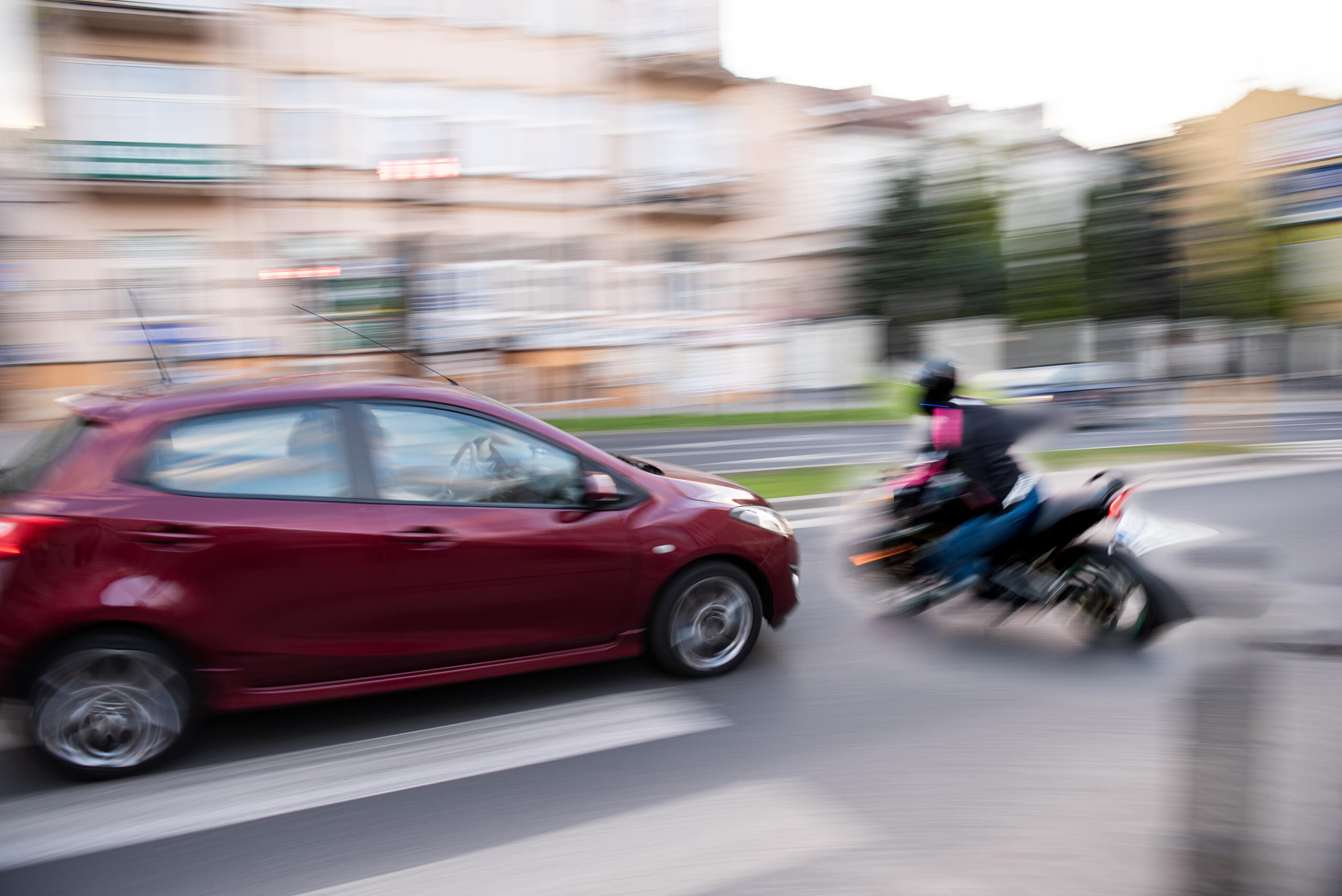 Motion blur of a speeding car colliding with a motorcycle, illustrating how speeding is a factor in 35% fatal accidents in Texas.