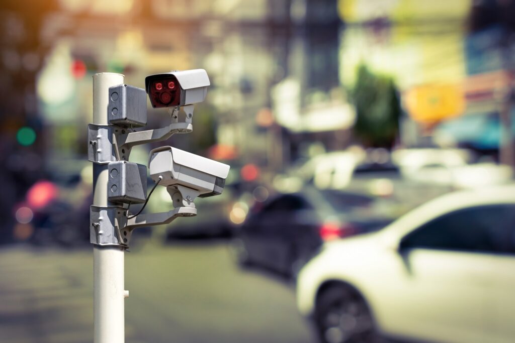 Traffic enforcement cameras at a busy Arlington intersection, used to document different types of car accidents in Texas.