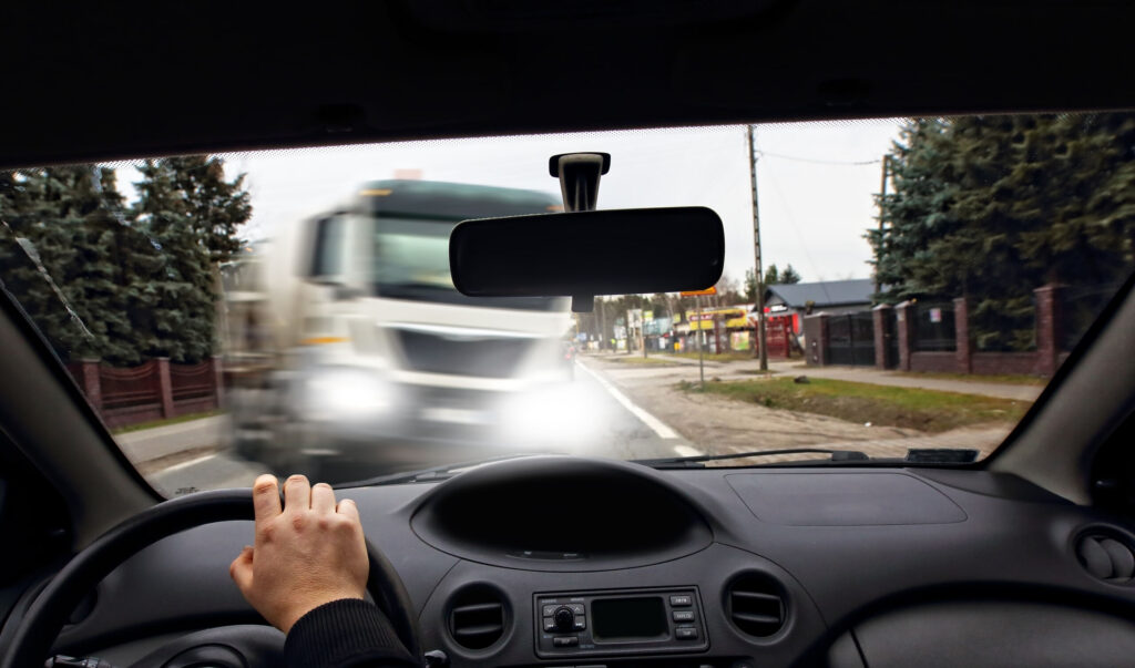 View from a car dashboard showing an oncoming semi-truck, illustrating a Texas truck accident settlement case.