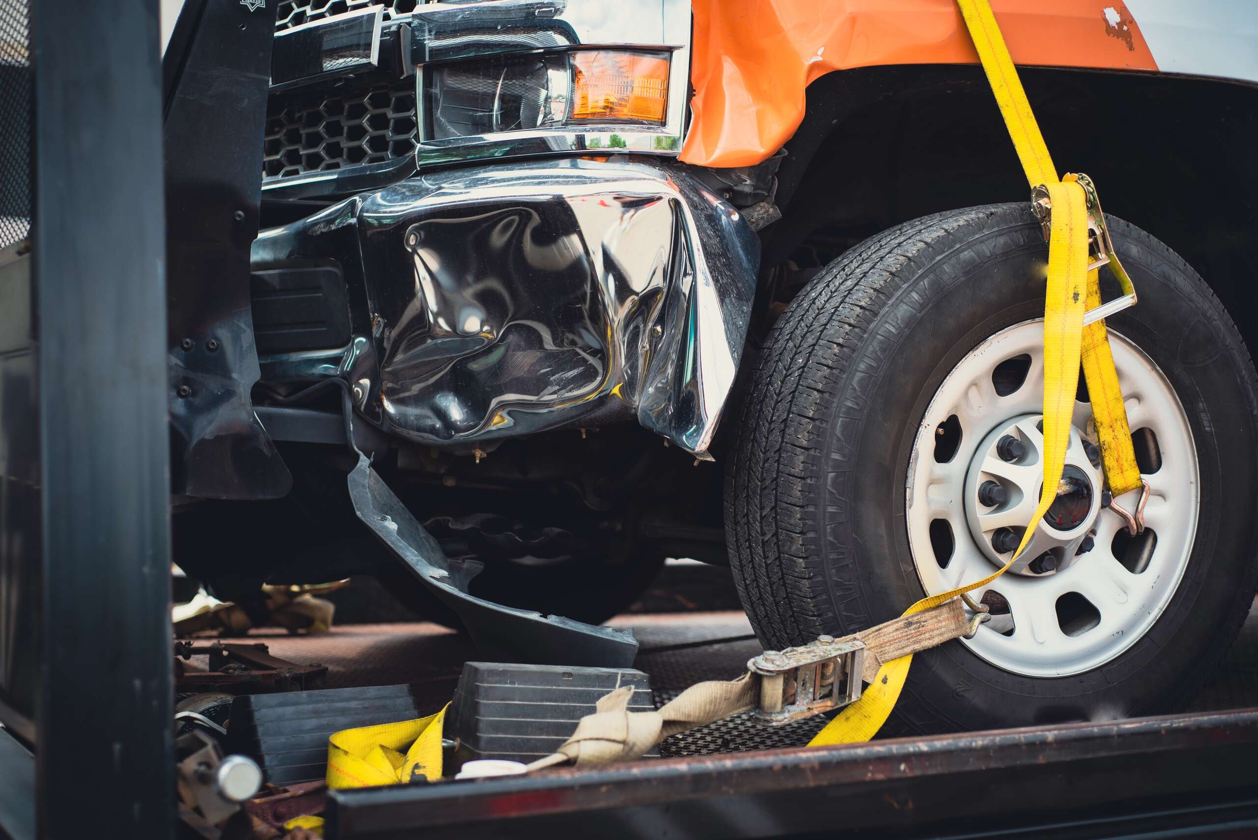 A heavily damaged pickup truck secured on a tow truck, highlighting the urgency of a Texas truck accident lawsuit.