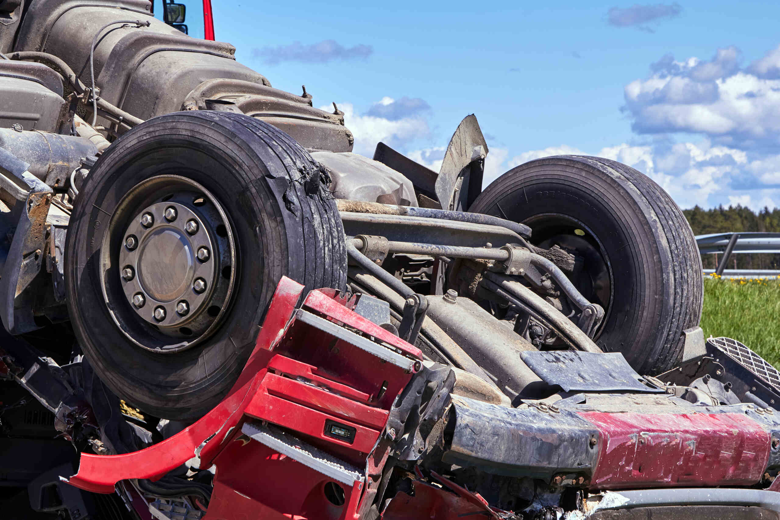 An overturned red semi-truck on a Texas highway, illustrating a rollover accident for this personal injury guide.