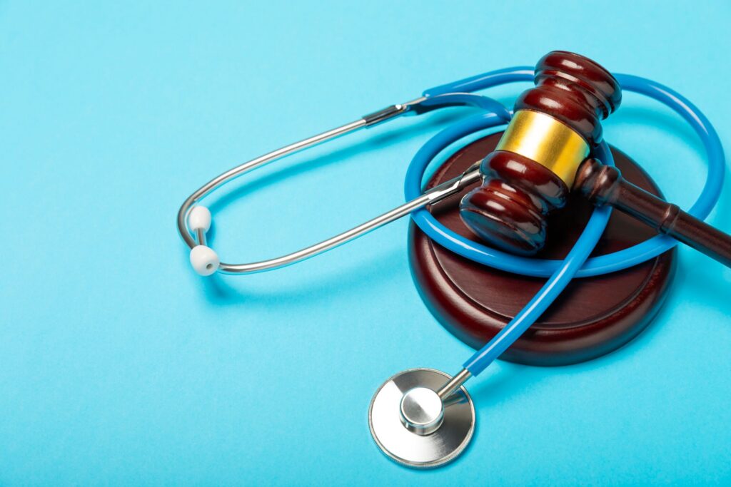 A legal gavel and scales of justice on a desk with attorneys working in the background, representing the post-deposition phase of a Texas personal injury lawsuit.