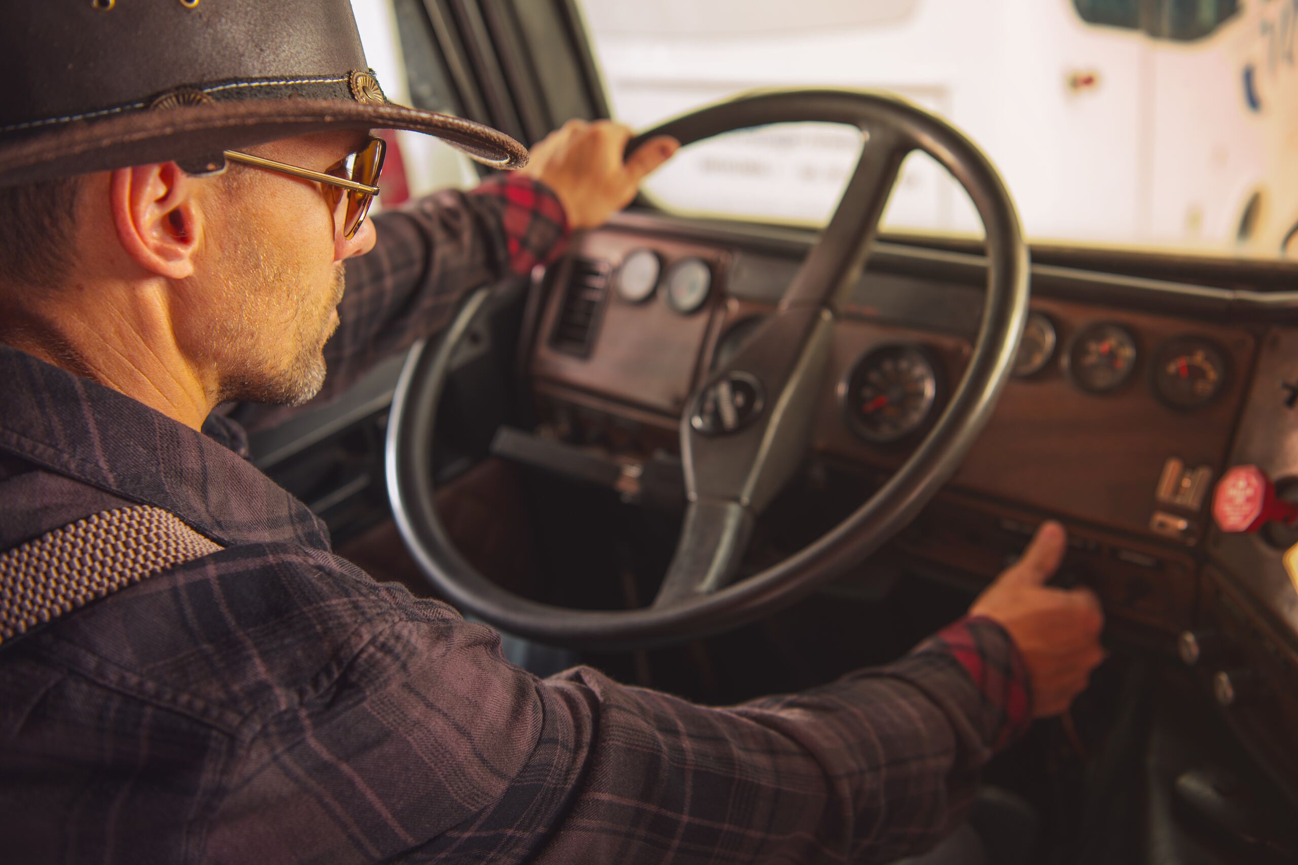 A truck driver in a cowboy hat behind the wheel, representing a driver involved in a Texas hit-and-run.