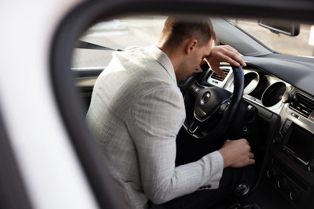 Drowsy driver showing signs of fatigue inside vehicle linked to serious Arlington car accidents caused by tired driving