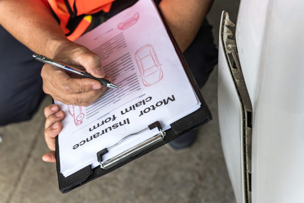 Car accident insurance claim paperwork being reviewed after a crash in Arlington, TX involving worsening injuries and questions about reopening a settlement claim