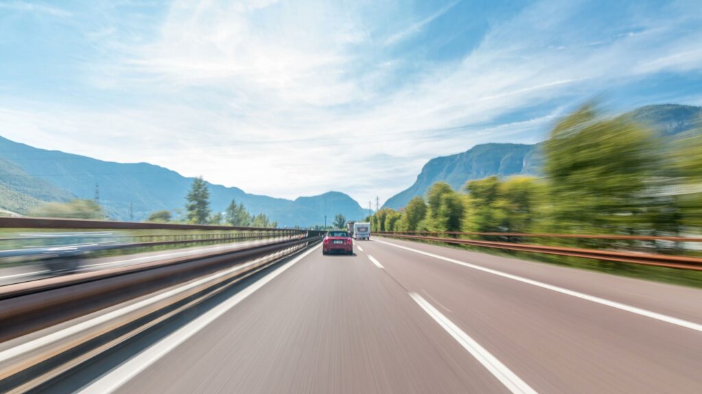 Motion-blurred highway traffic representing the dangers of impaired driving and increased crash risks caused by driving high in Texas