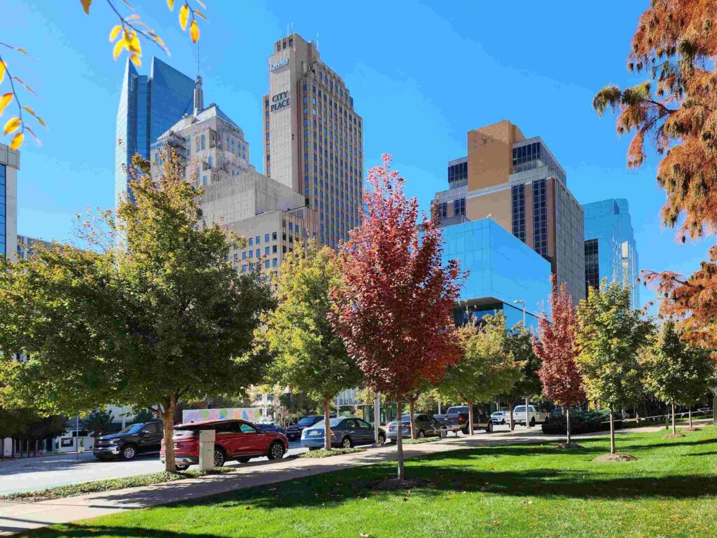 A downtown street scene in Oklahoma City featuring City Place Tower and autumn trees, providing geographic context for Oklahoma City Pedestrian Accident Attorneys.