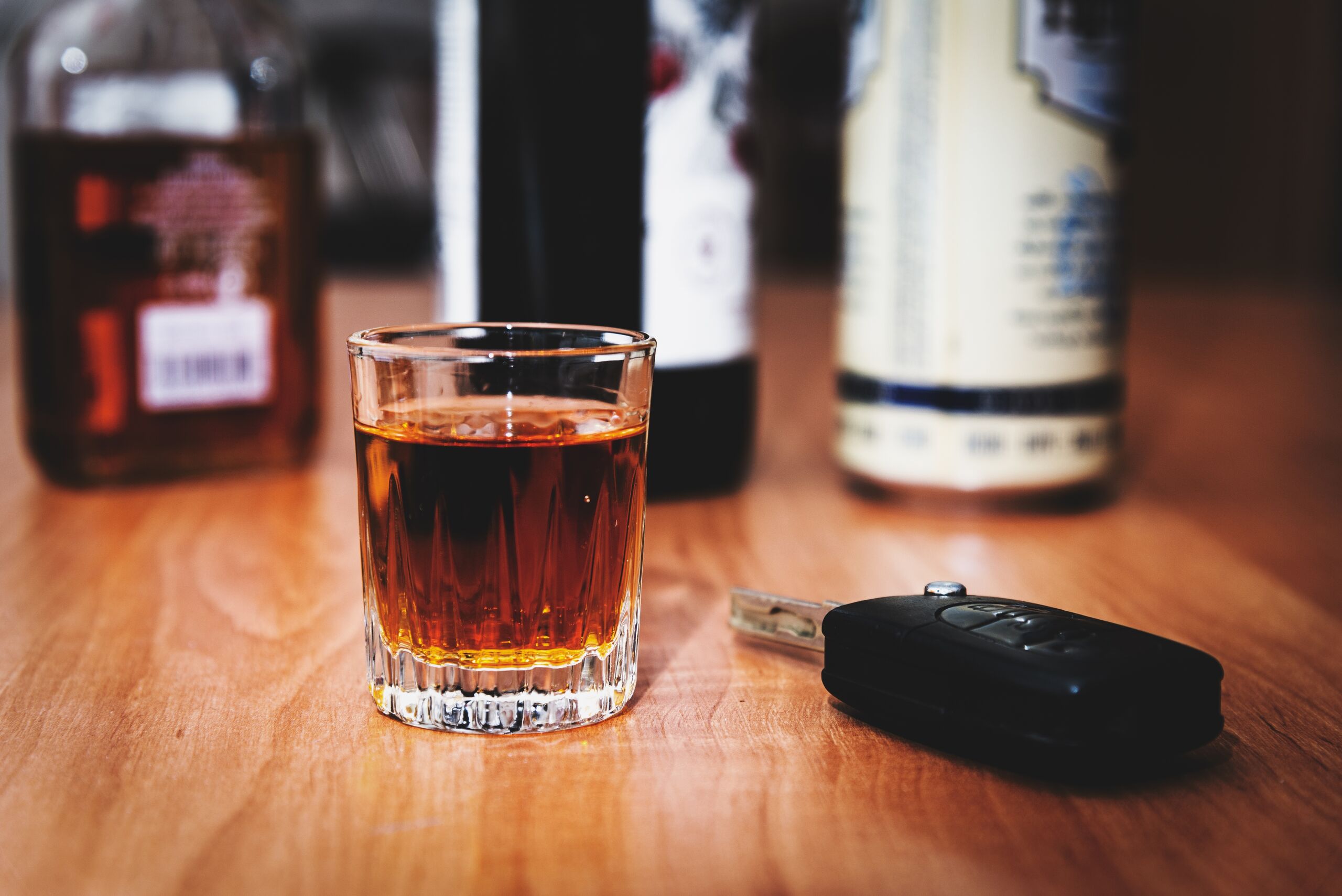 Alcohol shot glass and car keys representing cases handled by Oklahoma City dram shop liability lawyers.