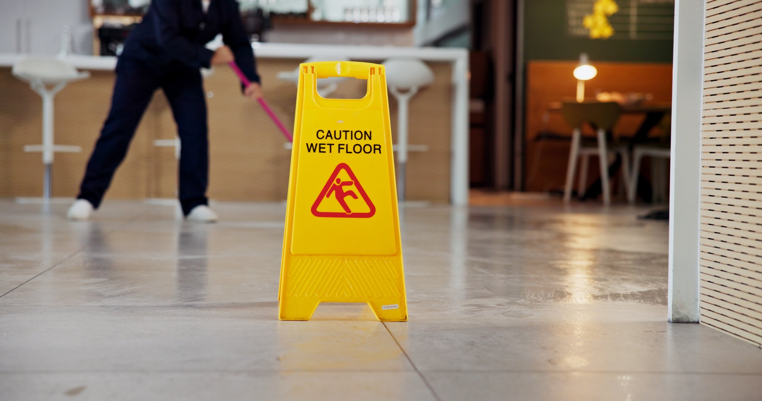 Caution wet floor sign in a restaurant, handled by Oklahoma City slip and fall lawyers.