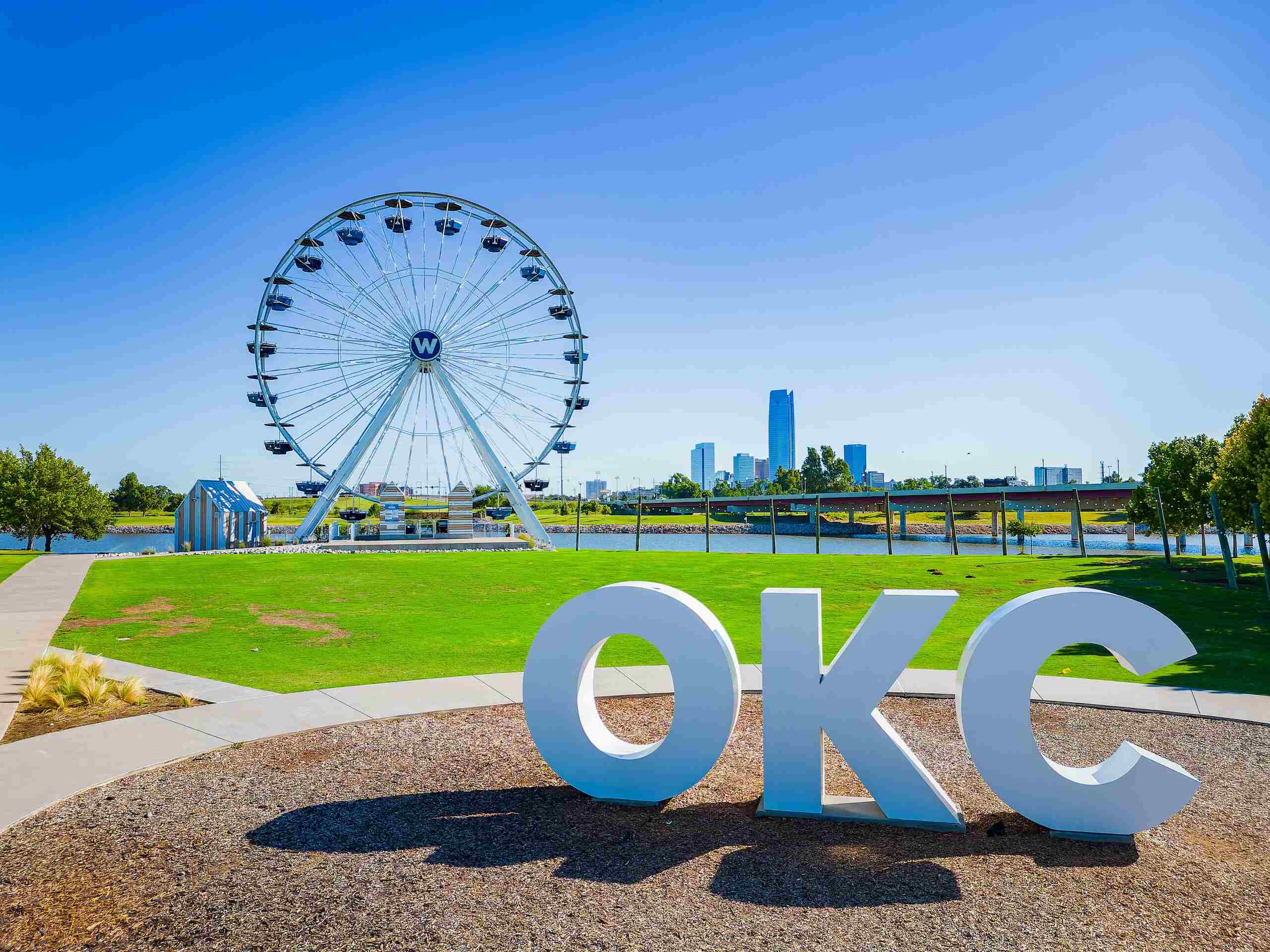 A large Ferris wheel framed by the city skyline highlights cases represented by Oklahoma City Amusement Park Accident Lawyers.